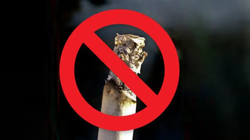 photo of burning cigarette with red no smoking warning